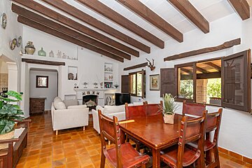 A living room with a table and chairs and a fireplace