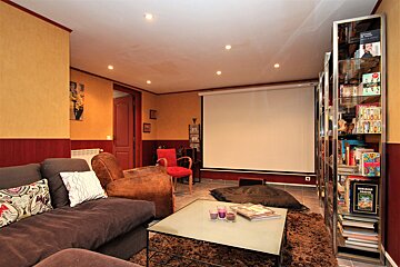 A living room with a couch and a projector screen
