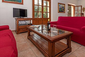 A bottle of wine sits on a coffee table in a living room