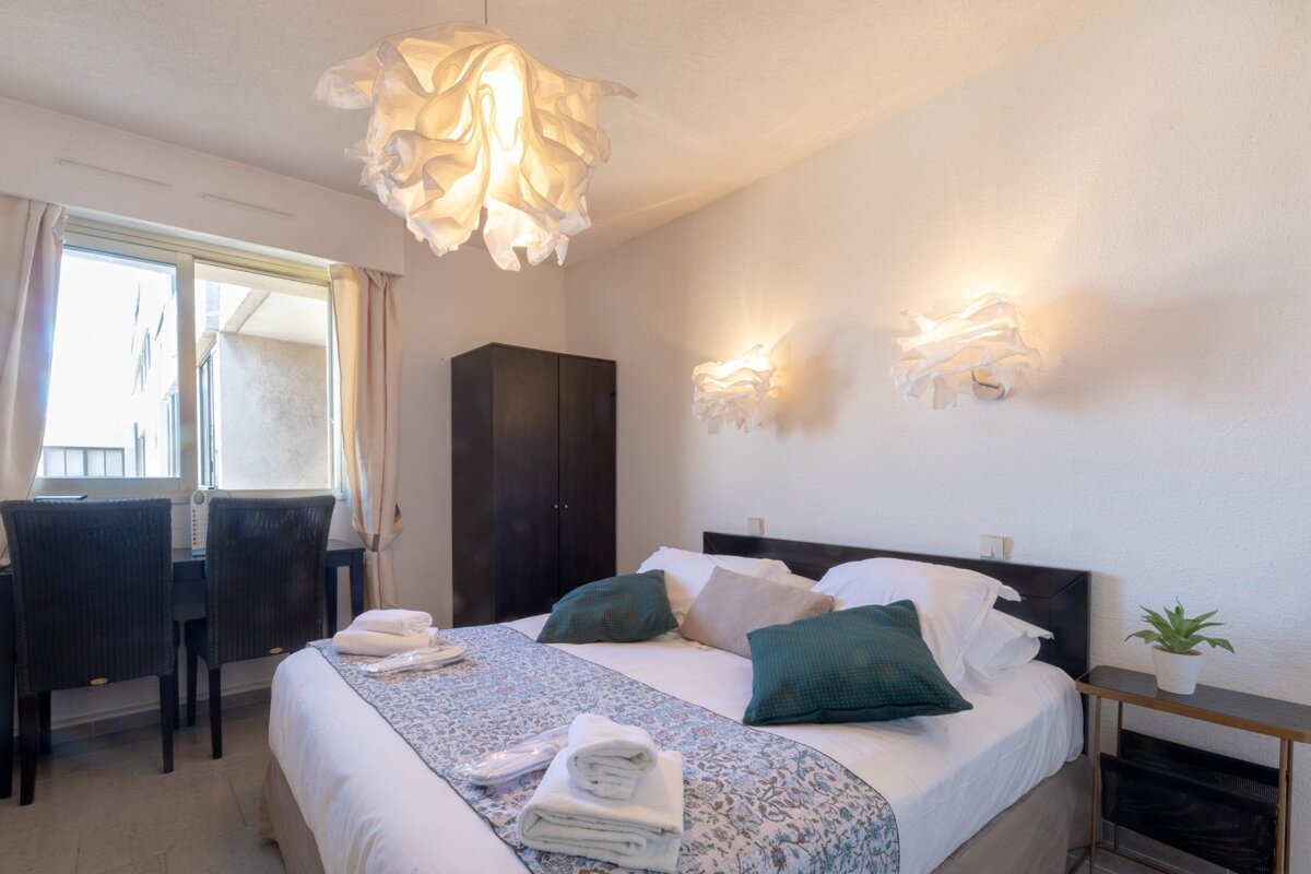 A bedroom with a large bed and a window