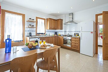 A kitchen with wooden cabinets and a white refrigerator