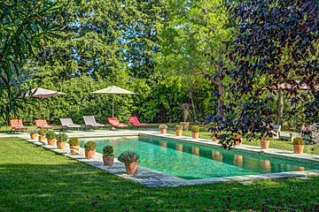 A large swimming pool surrounded by chairs and umbrellas