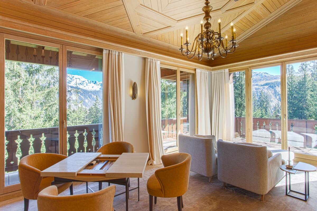 A room with a table and chairs and a chandelier