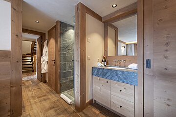 A bathroom with a sink and a walk in shower