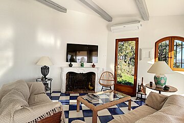A living room with a fireplace and a flat screen tv