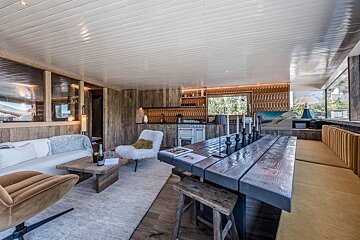 A living room with a wooden table and chairs