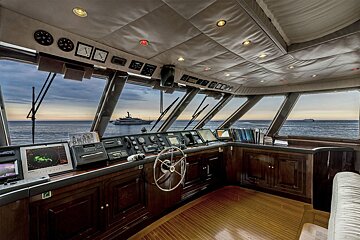 A boat with a steering wheel and a monitor that says ' gps ' on it