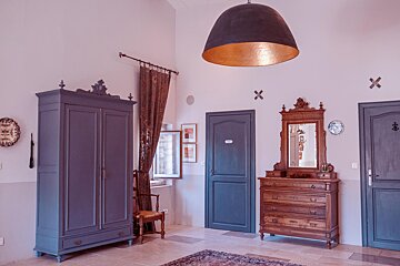 A room with a blue door and a dresser