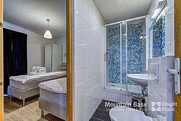 A bathroom with a knight frank logo on the wall