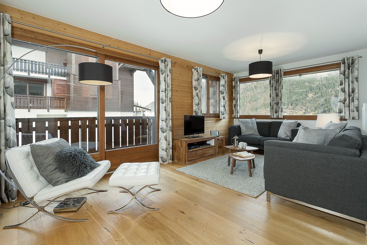 A living room with a couch a chair and a television