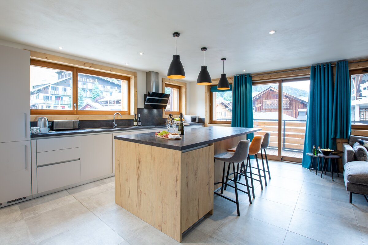 A kitchen with a large island in the middle