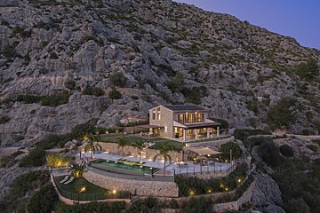 An aerial view of a house on top of a hill