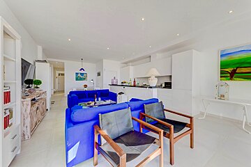A living room with a blue couch and two chairs