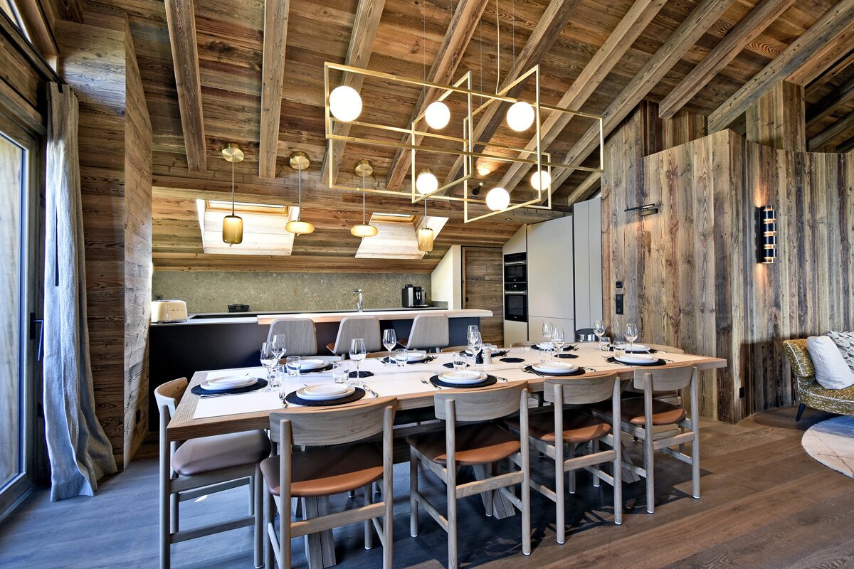 A dining room table with plates and glasses on it