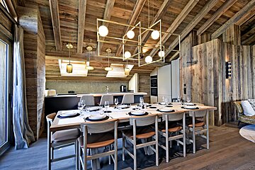 A dining room table with plates and glasses on it