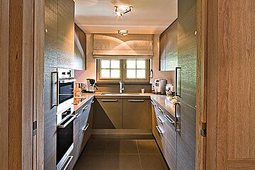 A narrow kitchen with a sink and a window
