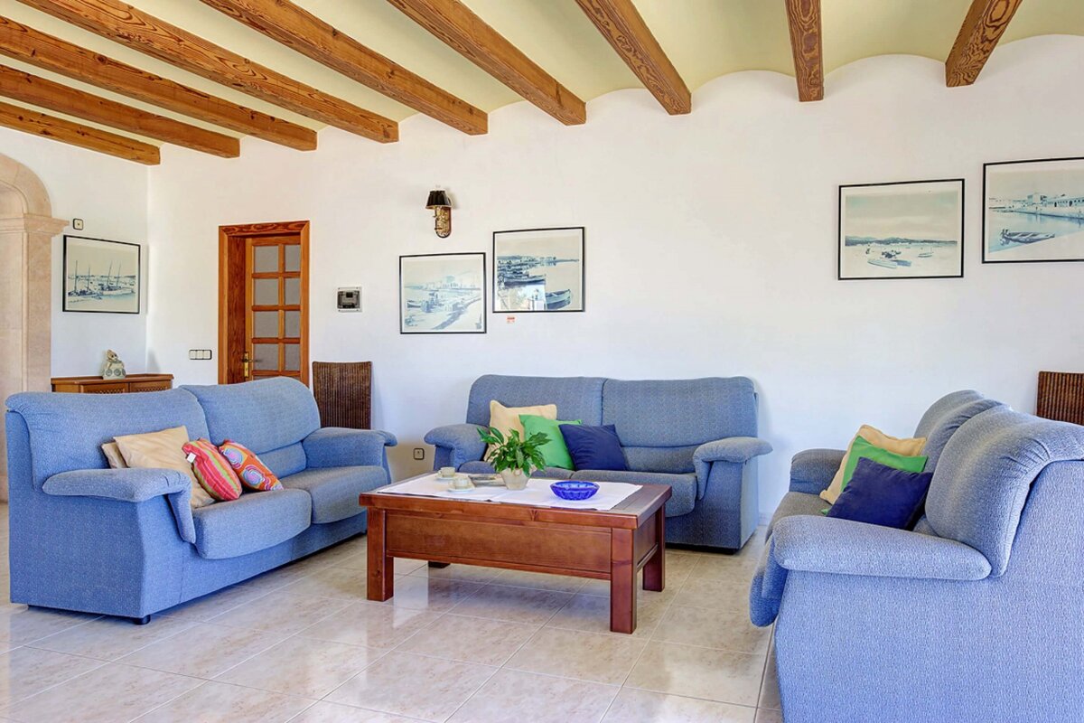 A living room with two blue couches and a coffee table