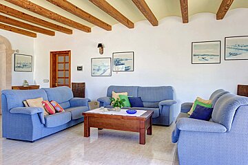 A living room with two blue couches and a coffee table