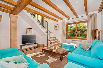 A living room with blue furniture and a flat screen tv