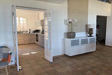 A kitchen with a white cabinet and a lamp