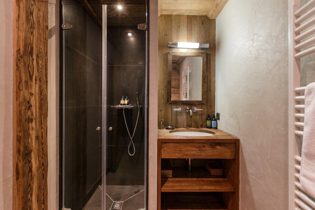 A bathroom with a sink and a walk in shower