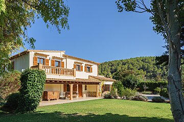 A house with a large lawn in front of it