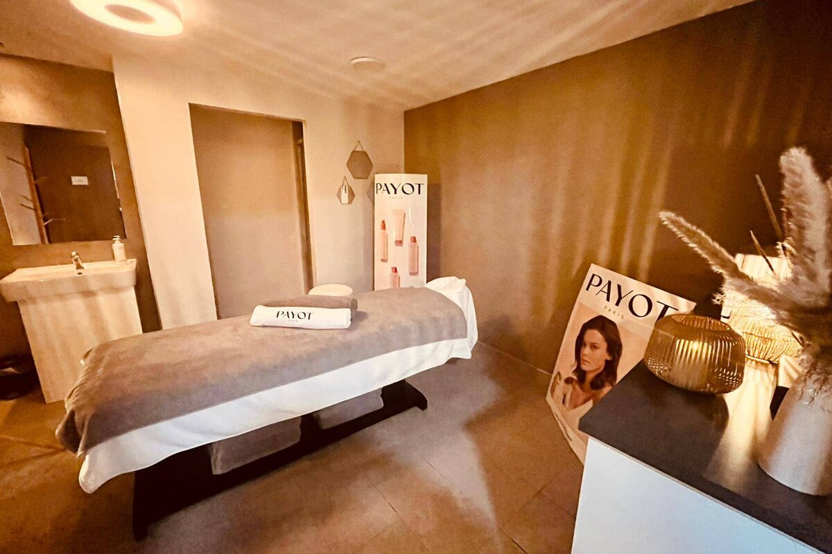 A payot sign hangs above a massage table