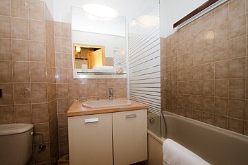A bathroom with a sink a toilet and a bathtub