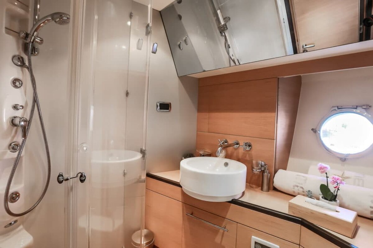 A bathroom with a sink a mirror and a shower