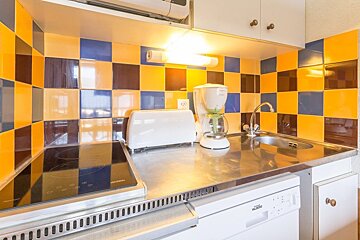 A kitchen with a toaster a coffee maker and a dishwasher