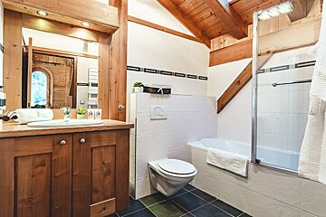A bathroom with a toilet a sink and a bathtub