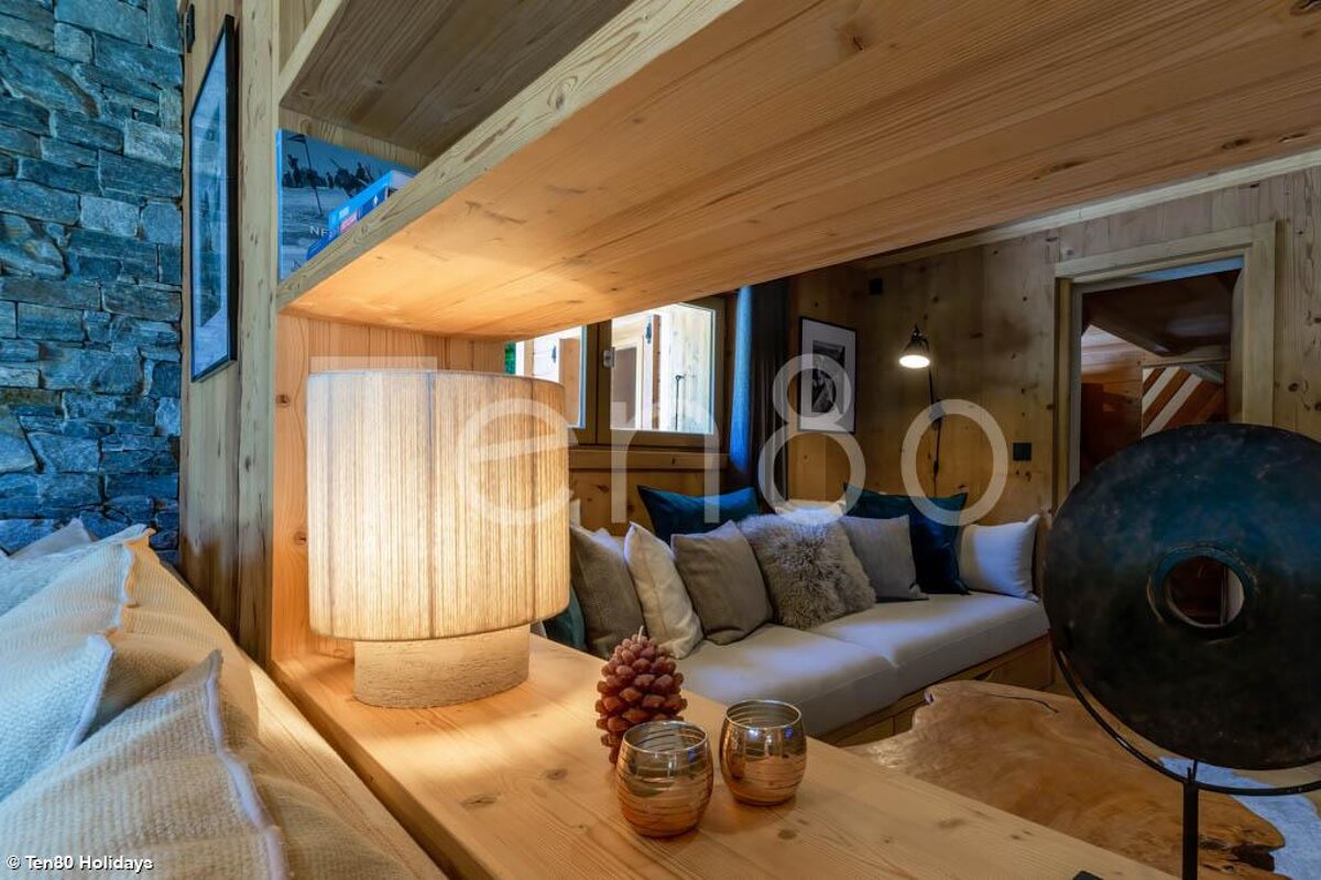 A lamp sits on a wooden table in a living room
