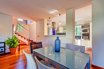 A dining room table with a blue vase on it