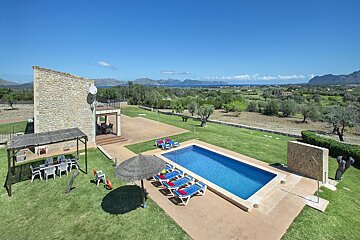A large swimming pool in the backyard of a house