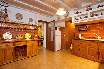 A kitchen with wooden cabinets and a white refrigerator