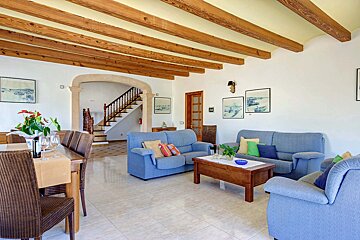 A living room with a blue couch and a table