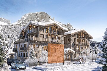 Snowy mountain resort with luxury stone-and-wood chalets, people, a car, and a highlighted orange section on one building.