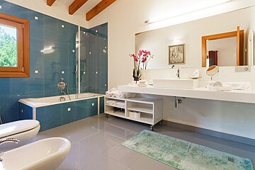 A bathroom with blue tiles and a white sink