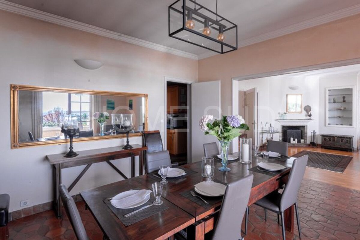 A dining room with a large mirror on the wall