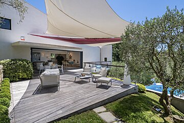 A patio with a red and white awning over it