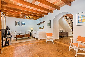 A living room with a white couch and orange chairs