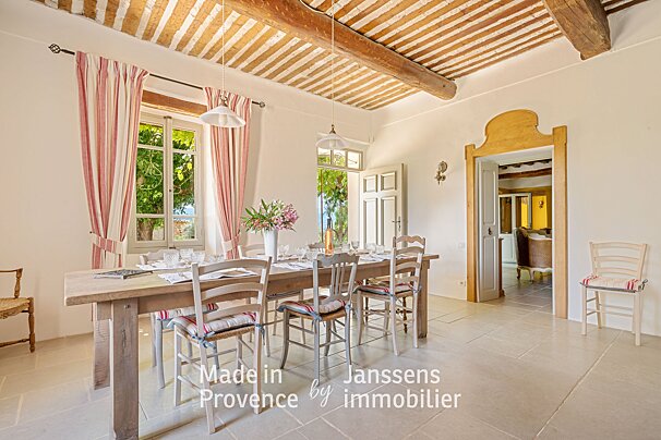 A dining room with a table and chairs made in provence by immobilier