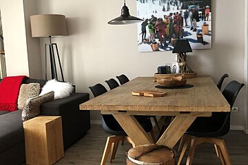A living room with a wooden table and chairs