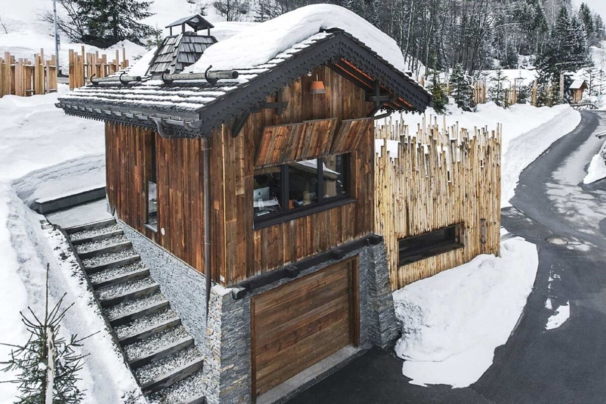 A small wooden house with stairs leading up to it