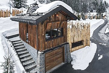 A small wooden house with stairs leading up to it