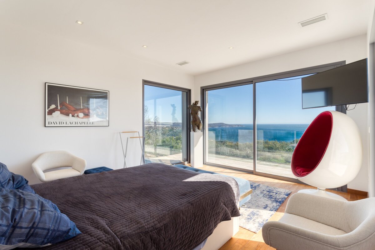 A bedroom with a painting of david lachapelle on the wall