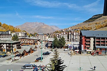 A view of a small town with a mountain in the background