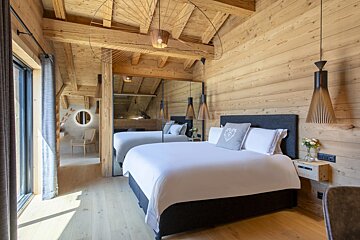 A bedroom with a large bed and a mirror