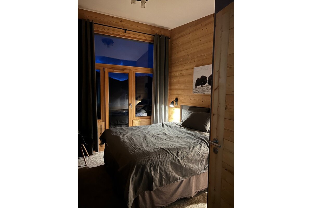 A bedroom with a bed and a picture on the wall