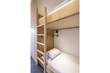 A bunk bed with a ladder leading up to it